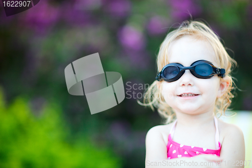 Image of Adorable toddler girl in swimming glasses