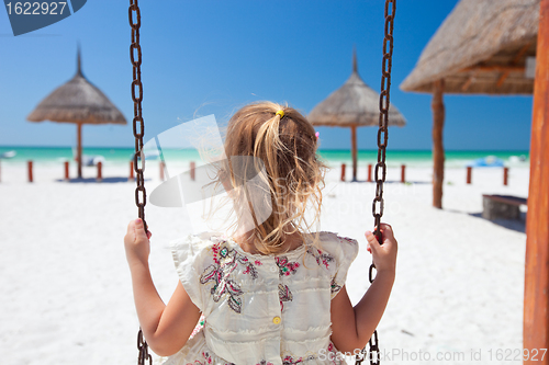 Image of Little girl swinging