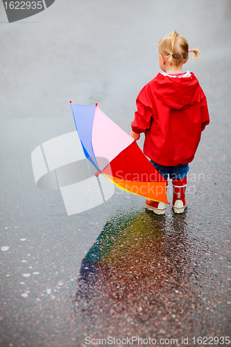 Image of Toddler girl outdoors at rainy day