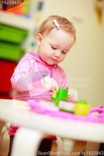 Image of Little girl playing with toys