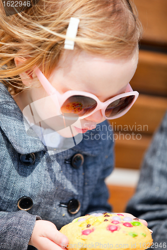 Image of Little girl eating cookie