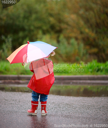 Image of Toddler girl outdoors at rainy day