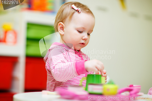 Image of Toddler girl playing with toys