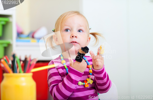 Image of Toddler girl playing with finger toys