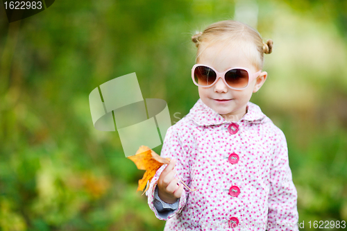 Image of Cute girl in autumn park