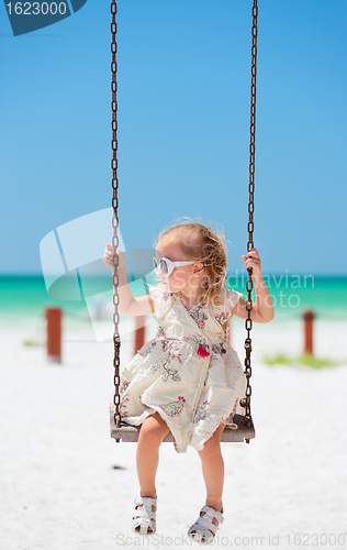 Image of Little girl swinging