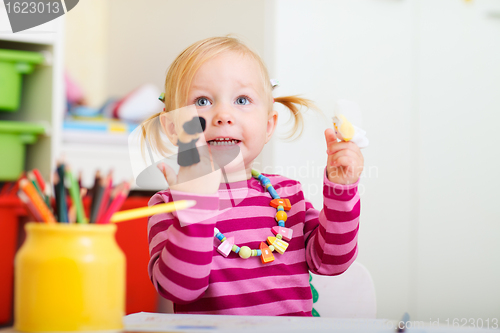 Image of Toddler girl playing with finger puppets