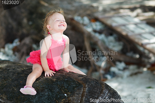 Image of Playful toddler girl in swimsuit