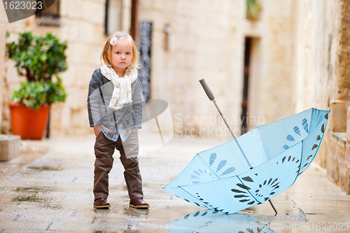 Image of Little girl on rainy day