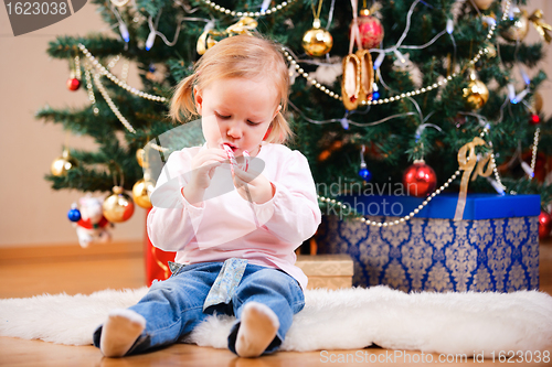Image of Toddler girl with Christmas candy