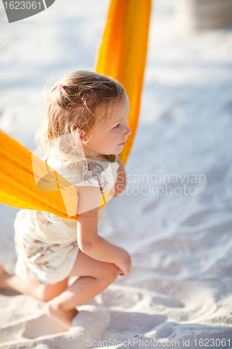 Image of Cute little girl swinging in hammock