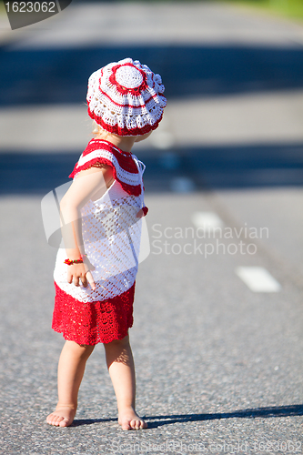 Image of Playful toddler girl on road