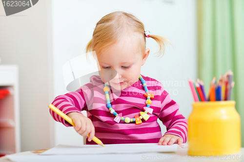 Image of Toddler girl drawing with pencils