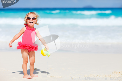 Image of Little girl playing at beach