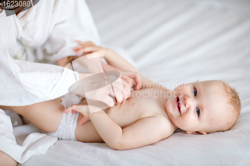 Image of Family playing in bed