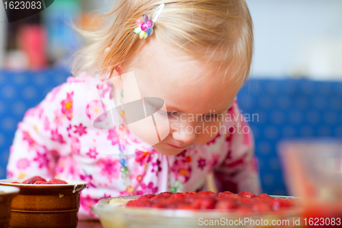 Image of Adorable toddler with strawberry pie