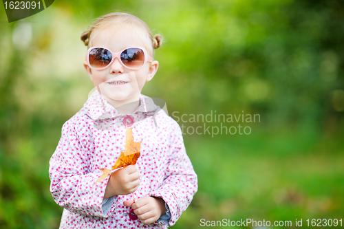 Image of Cute girl in autumn park