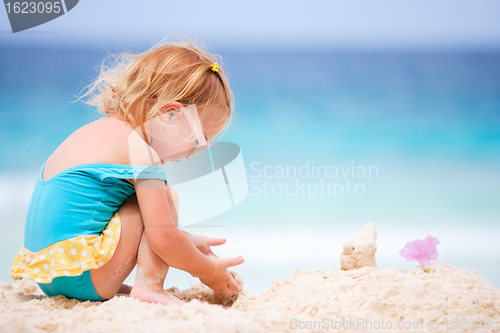 Image of Little girl playing at beach
