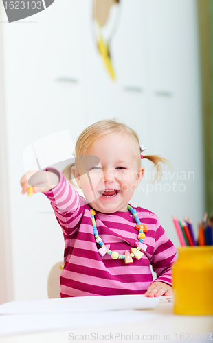 Image of Happy girl with coloring pencils