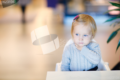 Image of Toddler girl sitting at table