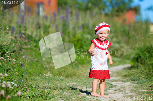 Image of Playful toddler girl in meadow