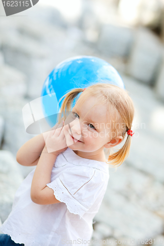 Image of Little girl with blue balloon