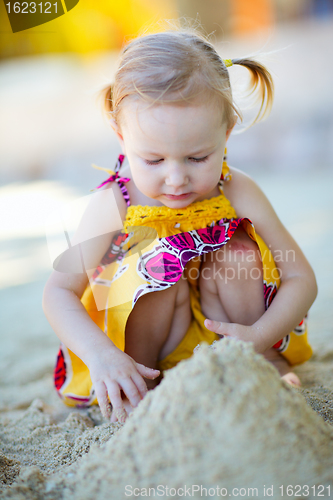 Image of Little girl playing at beach