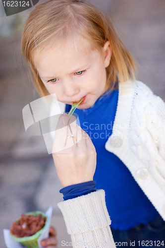 Image of Little girl eating ice cream