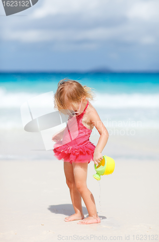 Image of Little girl playing at beach