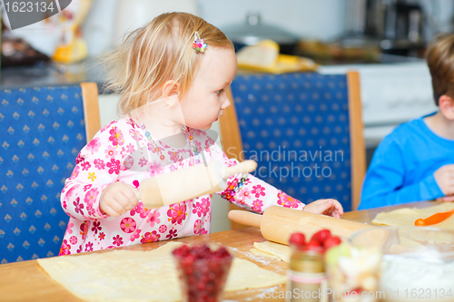 Image of Toddler girl helping at kitchen