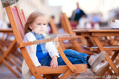 Image of Little girl at outdoor cafe