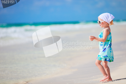 Image of Little playful girl at beach