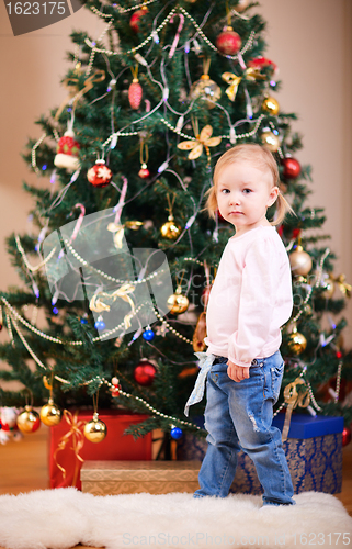 Image of Toddler girl near Christmas tree