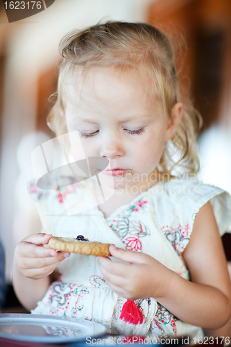 Image of Girl eating cookie