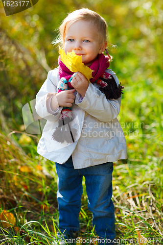 Image of Toddler girl with yellow leave