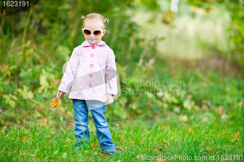 Image of Cute girl in autumn park