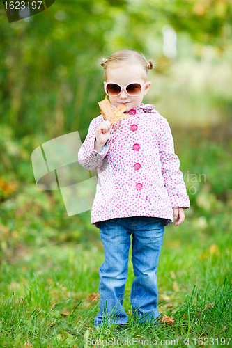 Image of Cute girl in autumn park