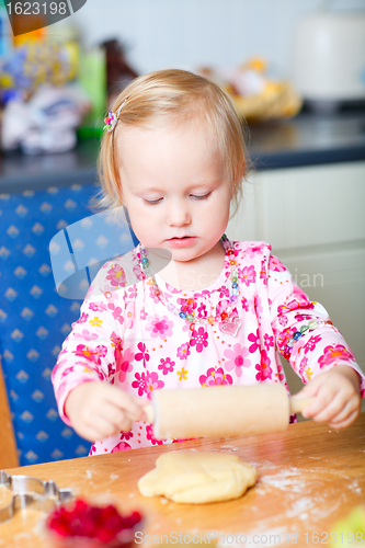 Image of Little girl helping at kitchen