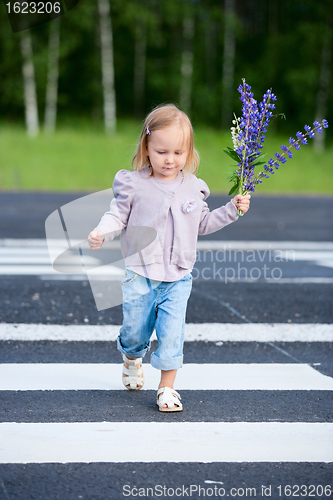 Image of Little girl crossing road