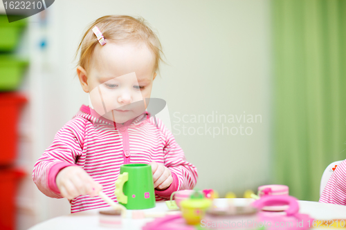 Image of Toddler girl playing with wooden toys