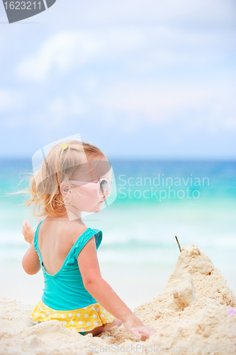 Image of Little girl playing with sand