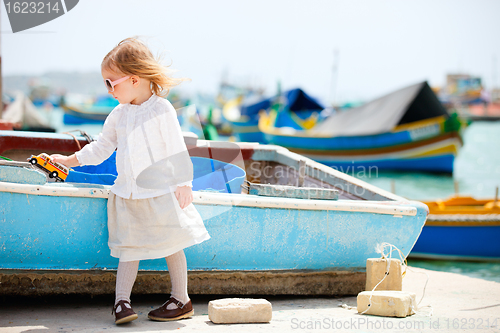 Image of Little girl playing with toy bus