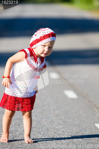 Image of Playful toddler girl on road