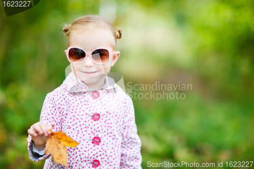Image of Cute girl in autumn park