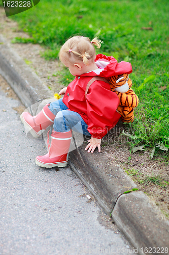 Image of Toddler girl outdoor at rainy day