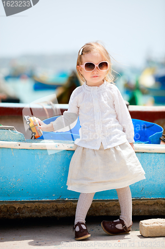 Image of Little girl playing with toy bus