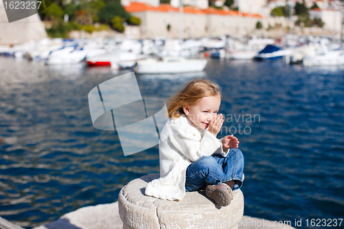 Image of Little girl enjoying sea view