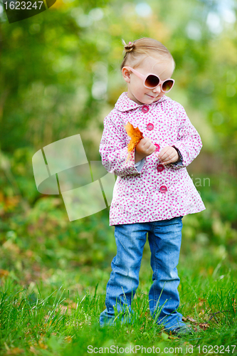 Image of Cute girl in autumn park