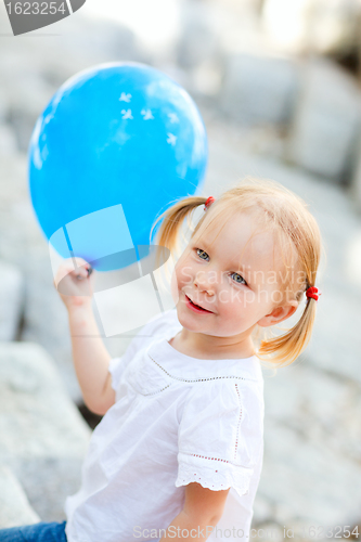 Image of Little girl with blue balloon