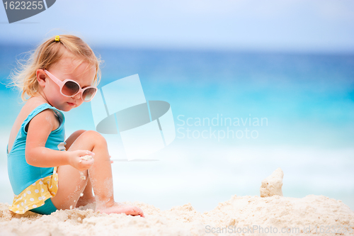 Image of Little girl playing at beach